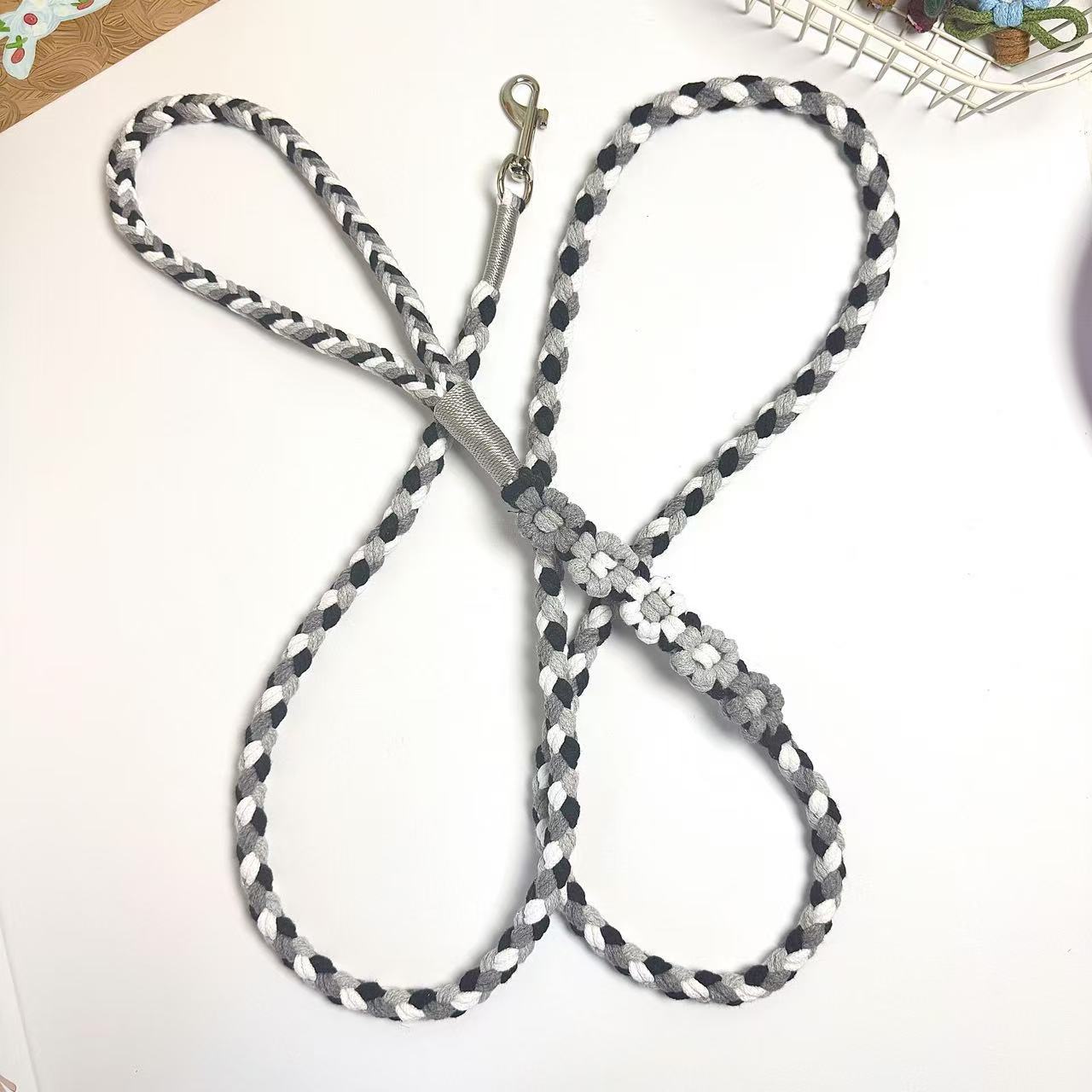 Handmade five flowers series black gray dog leash displayed on a white surface with decorative elements, arranged to look like a butterfly.