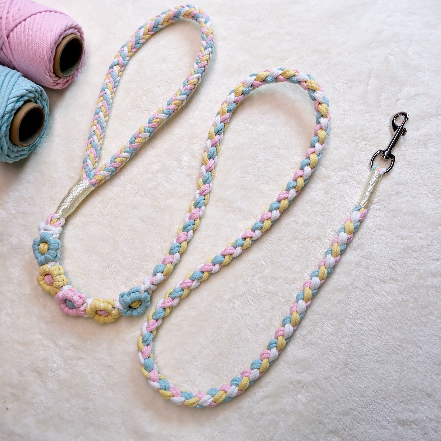 Handmade five flowers series blue yellow dog leash placed on a cotton cloth