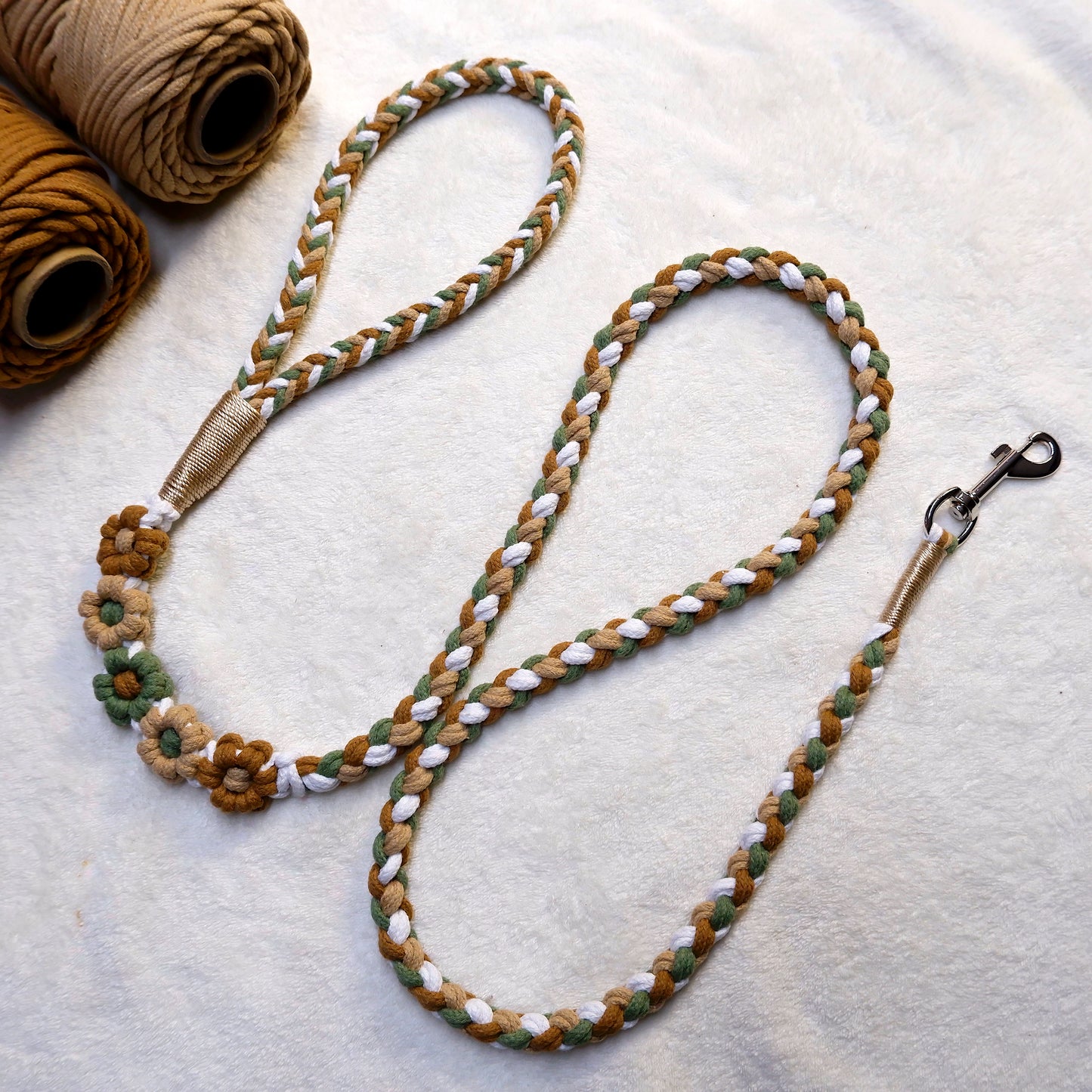 Handmade five flowers series brown green dog leash placed on a cotton cloth