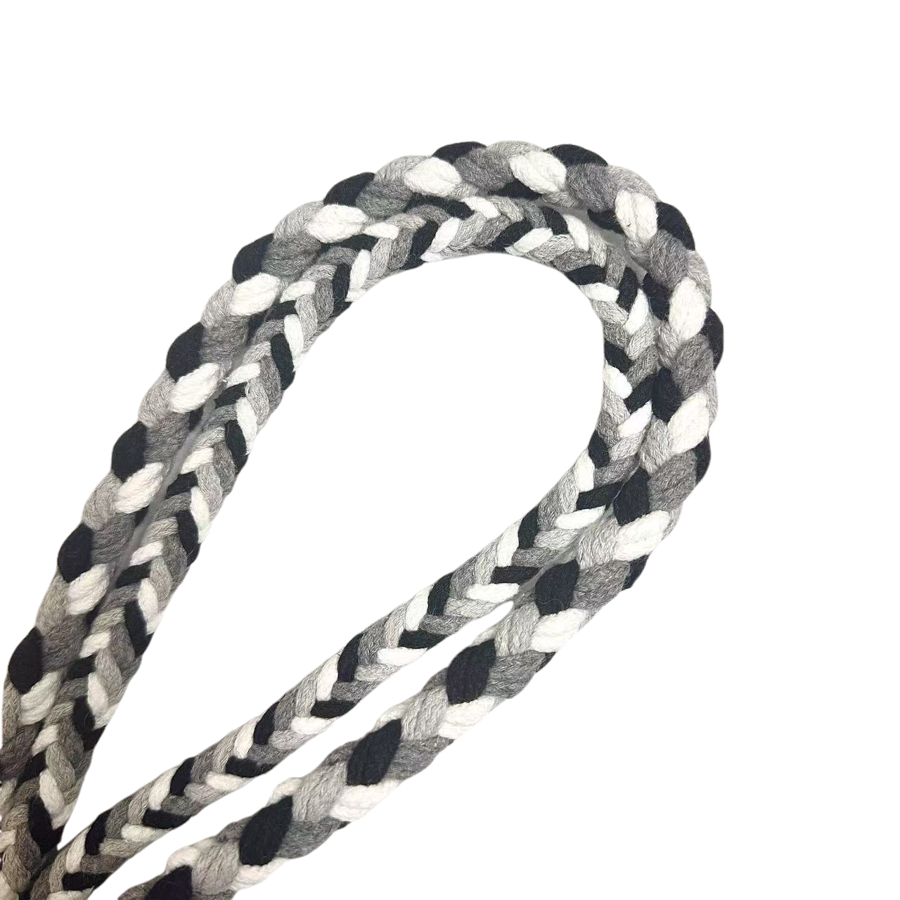 A detailed view of a black, gray, and white braided dog leash, highlighting its sturdy handwoven handle section and the neatly arranged leash cord.