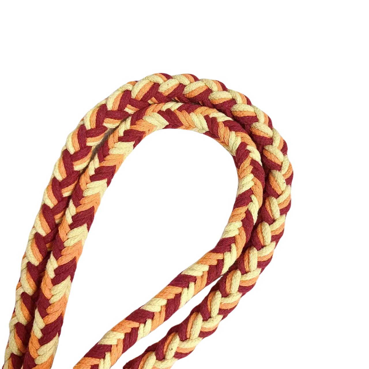 A detailed view of an orange, red, and yellow braided dog leash, highlighting its sturdy handwoven handle section and the neatly arranged leash cord.