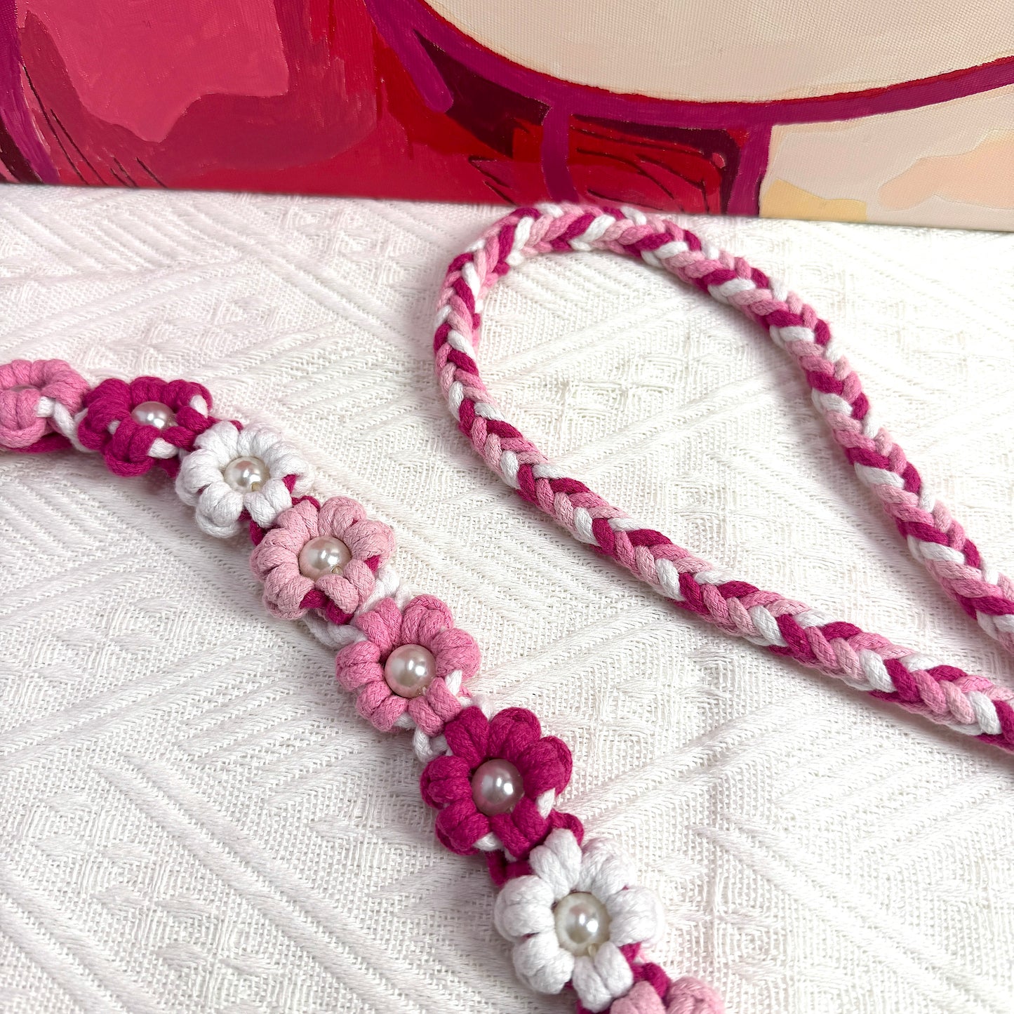 The soft handle of the handmade pink white dog leash, decorated with numerous handcrafted flowers in elegant pink and white tones.