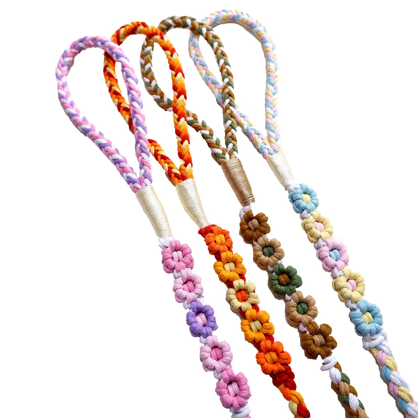 Four five-flower handmade dog leashes are laid out in parallel, elegantly showcasing the handwoven floral sections and the beautifully crafted handle portions.