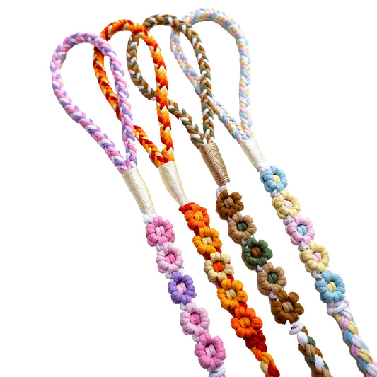 Four five-flower handmade dog leashes are laid out in parallel, elegantly showcasing the handwoven floral sections and the beautifully crafted handle portions.