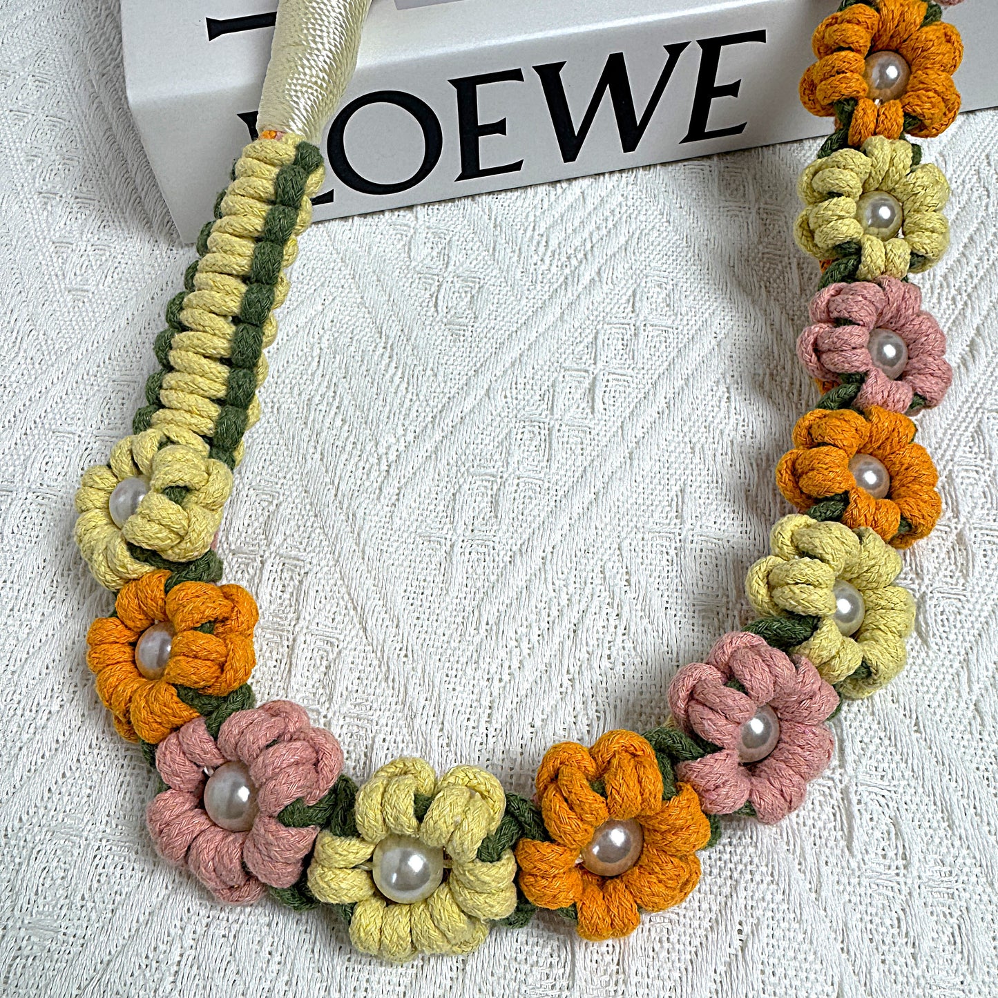 Dog leash decorated with numerous handcrafted flowers in blossom yellow, orange and pink tones.