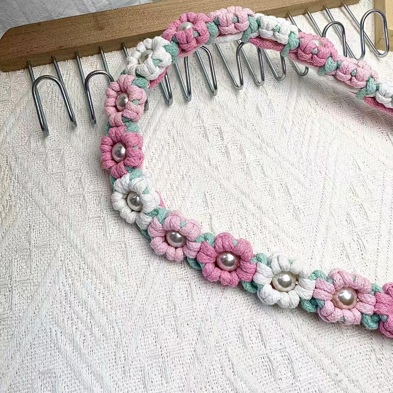 Dog leash decorated with numerous handcrafted flowers in eye-catching pink, light blue, and white tones.