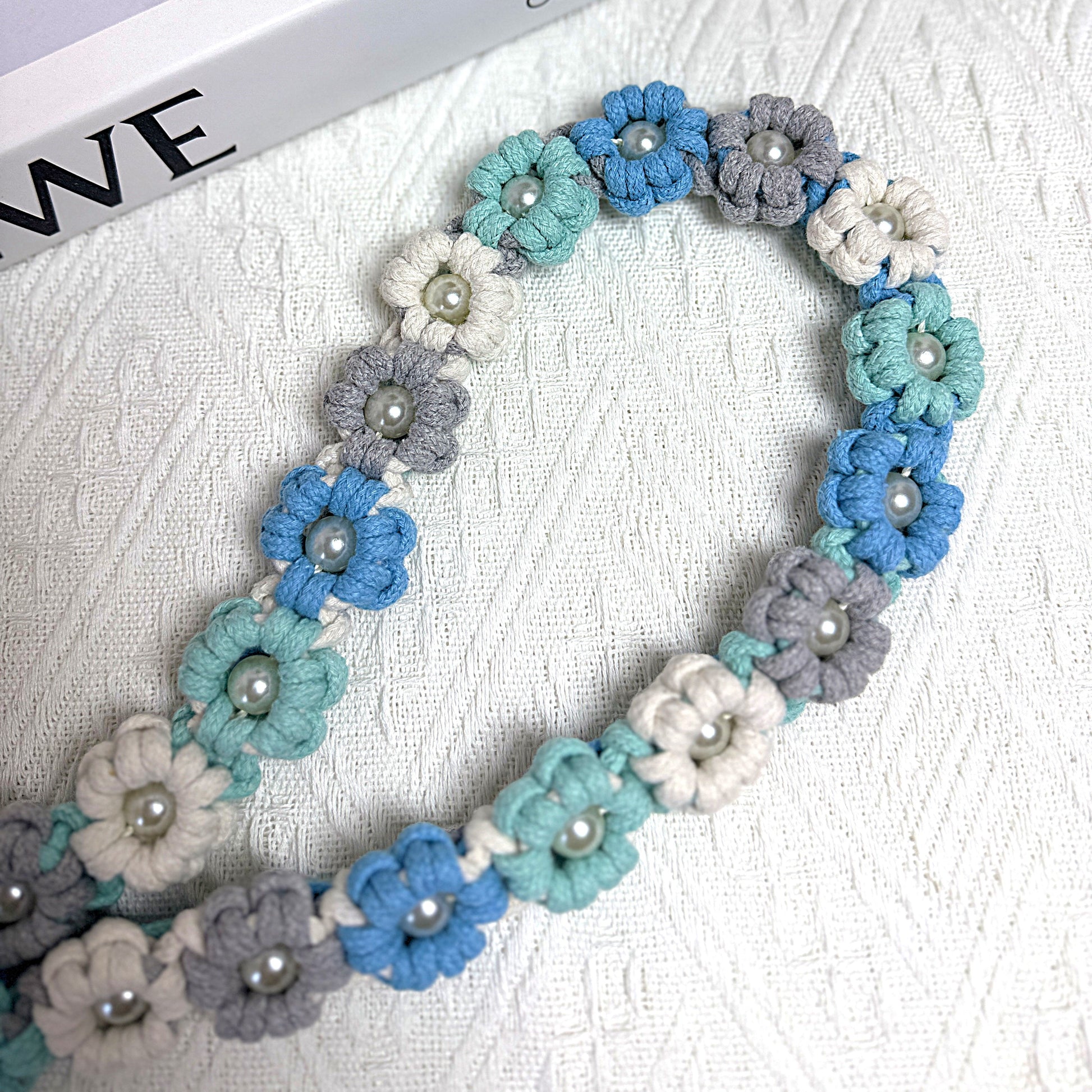 Dog leash decorated with numerous handcrafted flowers in classic blue, gray and white tones.