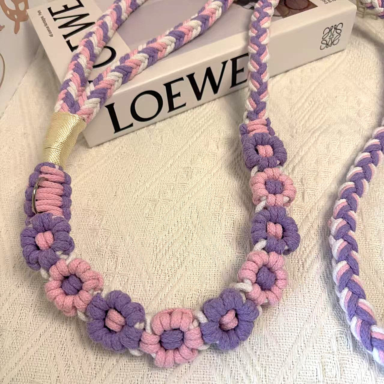 Handmade dog leash decorated with nine handcrafted flowers in elegant purple and pink tones.