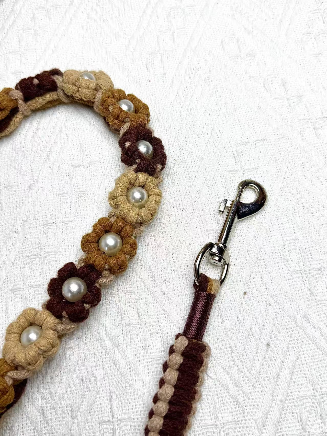 A close-up of a gradient brown handwoven dog leash, showcasing the durable braided design and a polished metal clip for secure attachment.