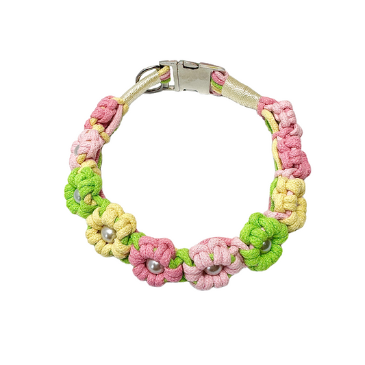 A green and yellow handmade dog collar featuring braided flower patterns with pearl embellishments, adding a touch of delight to your pet's life.
