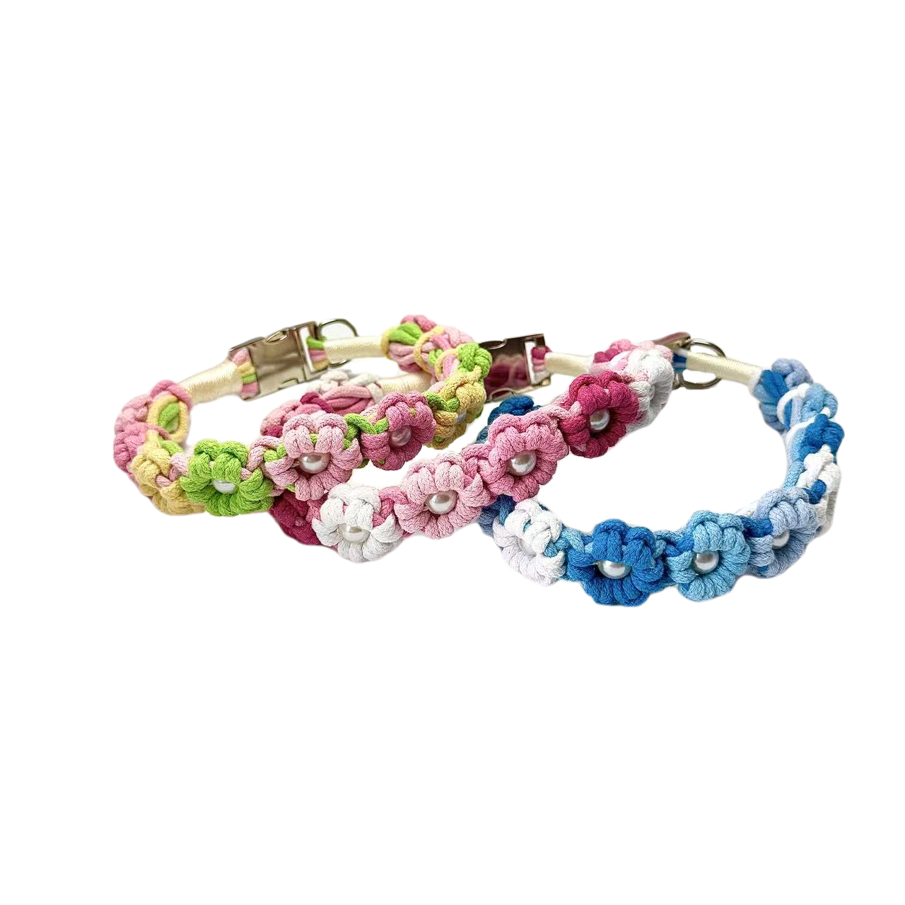 A set of three colorful handmade dog collars with braided flower patterns in pink, green, and blue, featuring metal clasps for secure fastening.