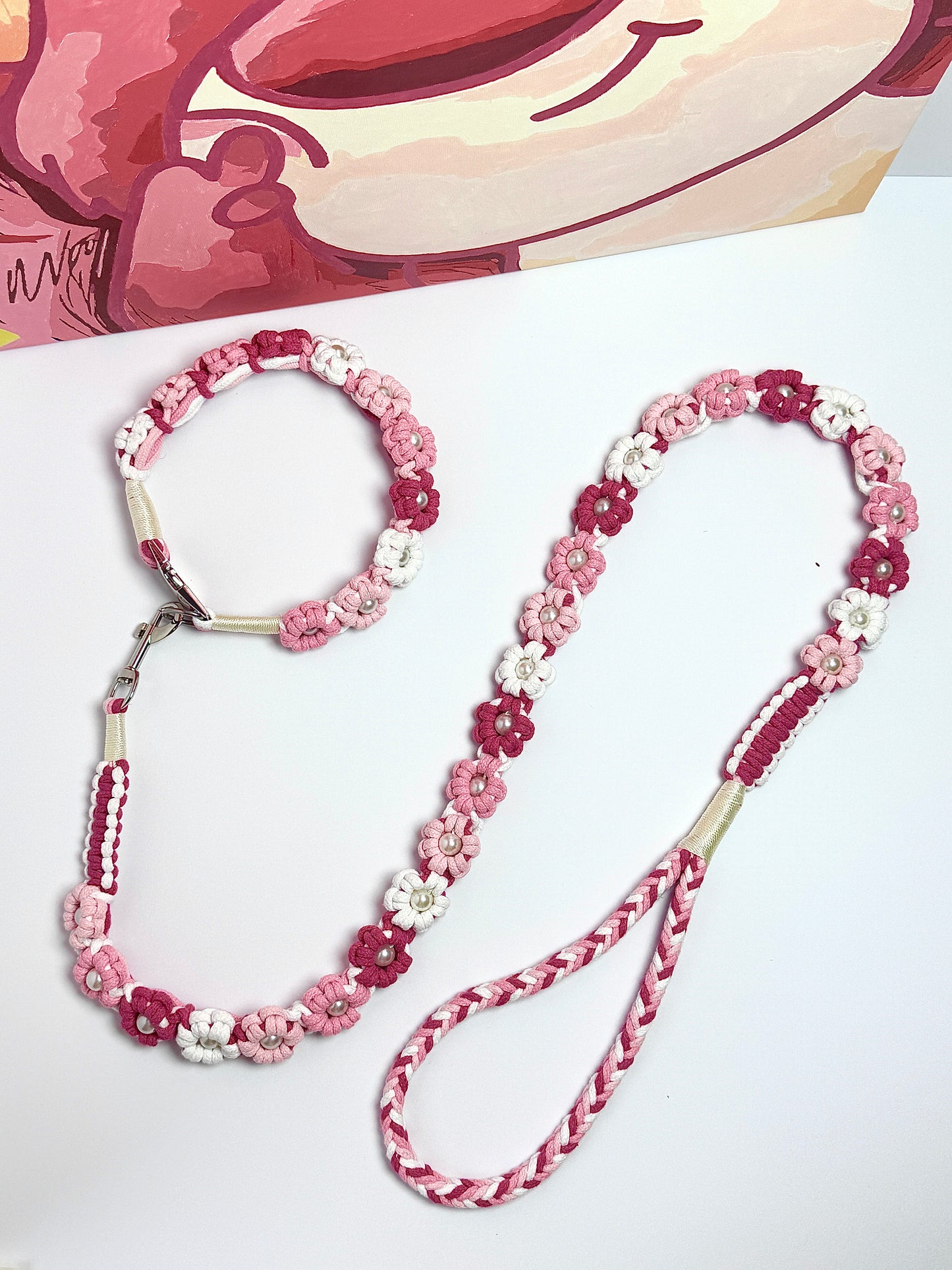 Beautiful handmade dog leash and collar set, featuring elegant pink and white floral designs with pearl accents. Perfect for adding a touch of charm to your pet's daily walks.