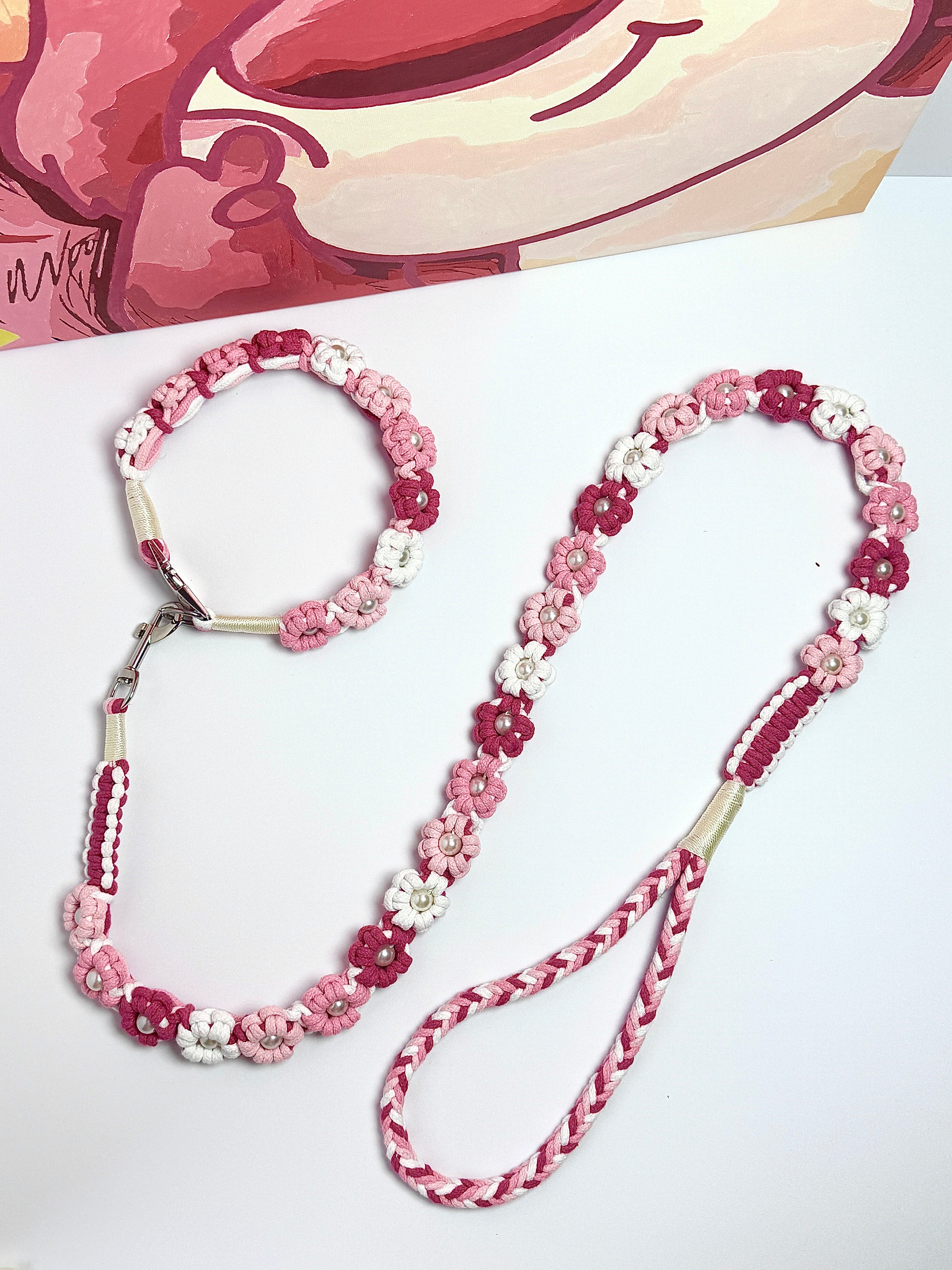 Beautiful handmade dog leash and collar set, featuring elegant pink and white floral designs with pearl accents. Perfect for adding a touch of charm to your pet's daily walks.