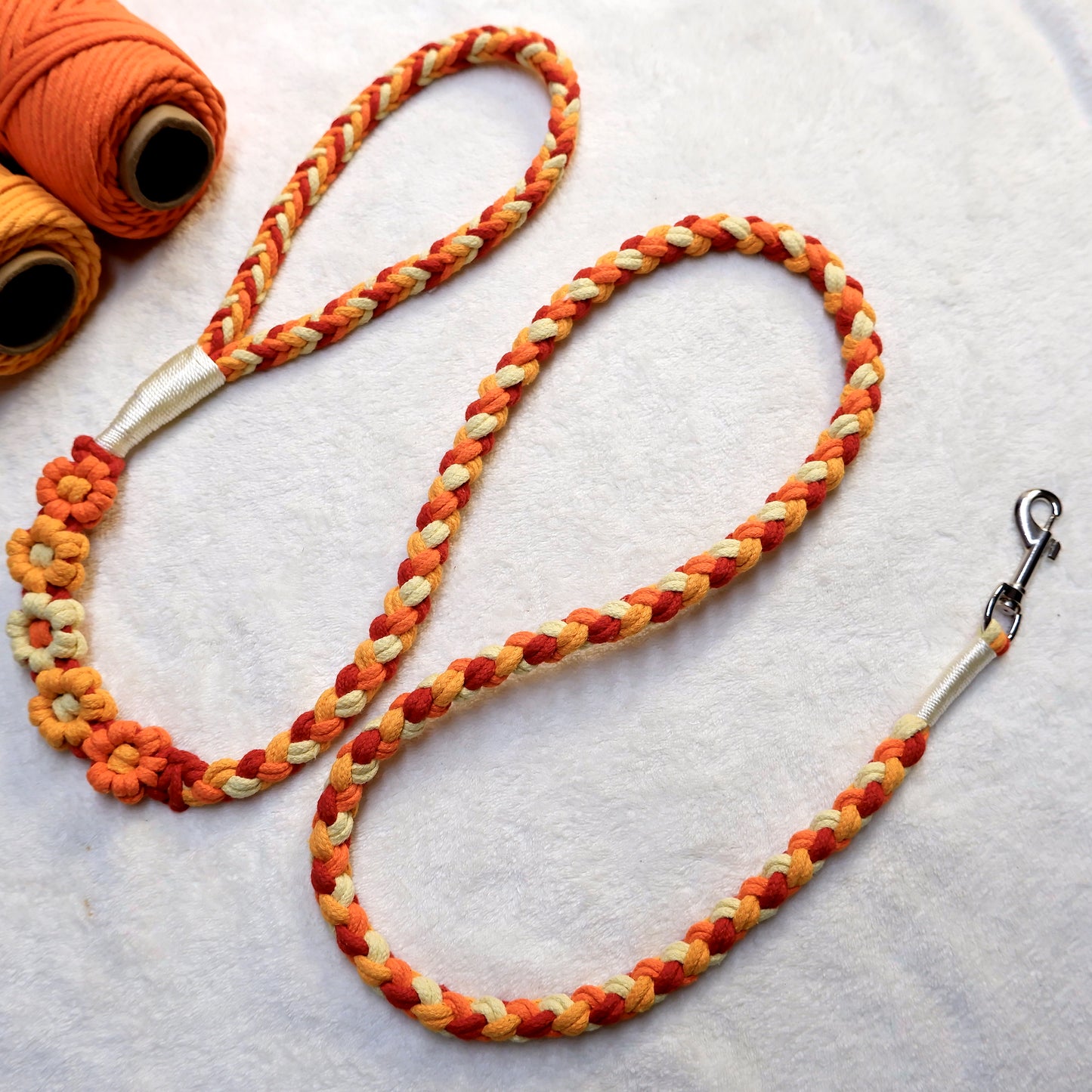 Handmade five flowers series orange yellow dog leash placed on a cotton cloth