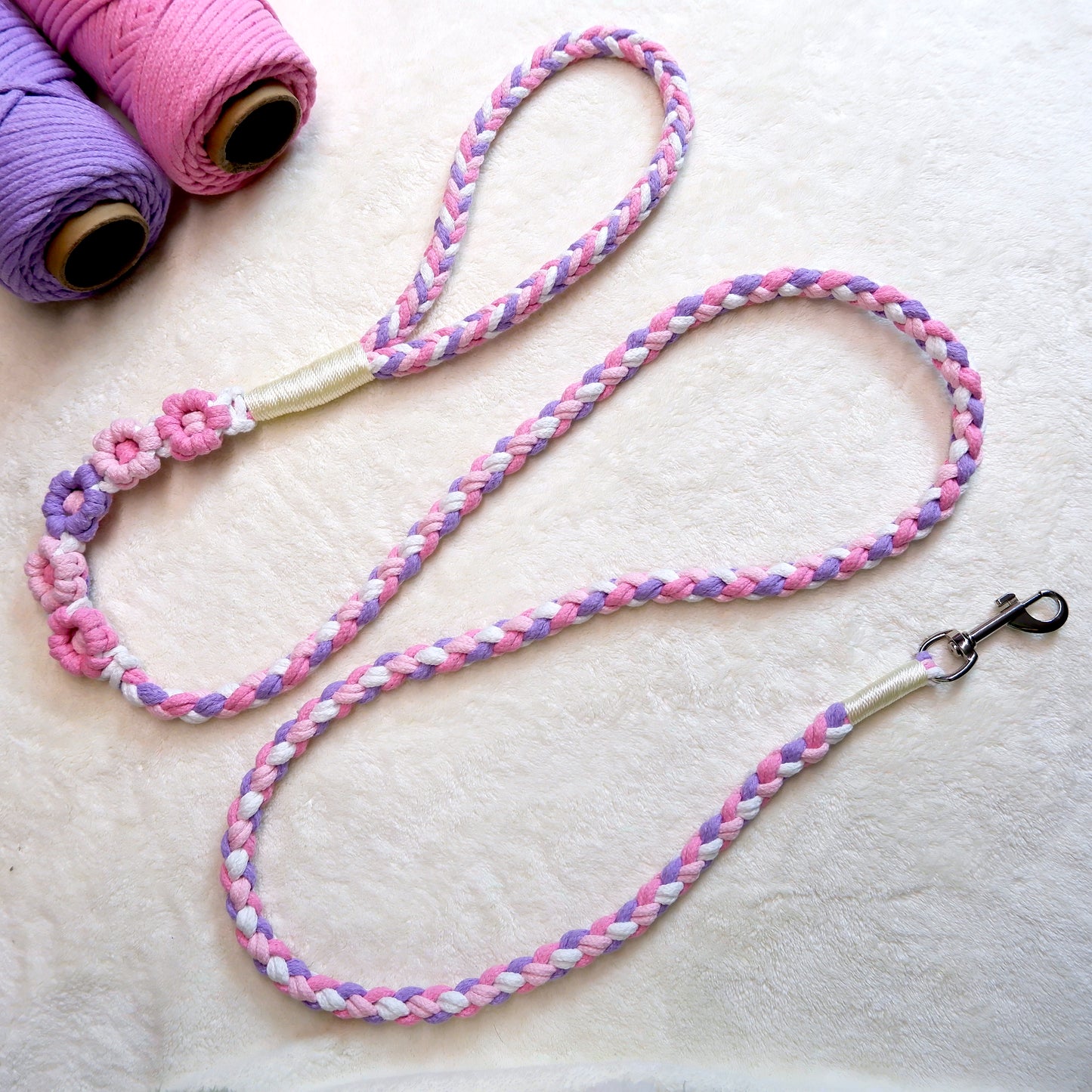 Handmade five flowers series purple pink dog leash placed on a cotton cloth
