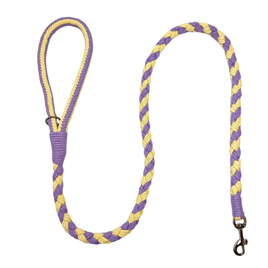 A purple and yellow handmade dog leash crafted from braided cotton with a soft handle and a secure metal clip, perfect for everyday use.