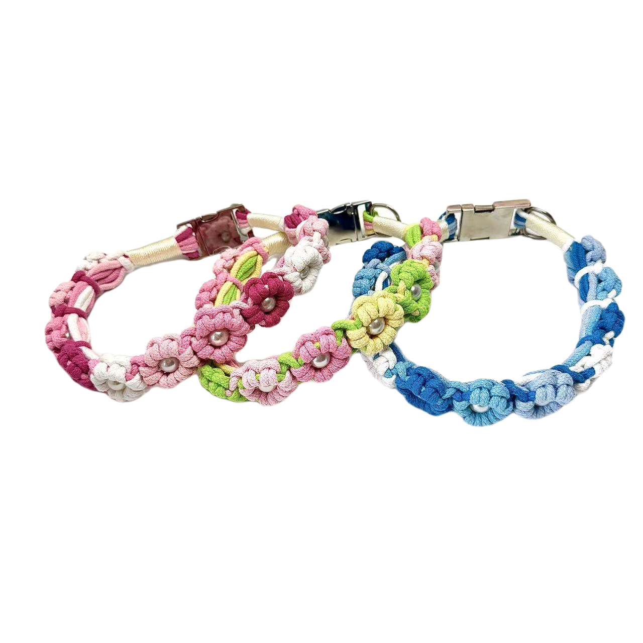 A set of three colorful handmade dog collars with braided flower patterns in pink, green, and blue, featuring metal clasps for secure fastening.