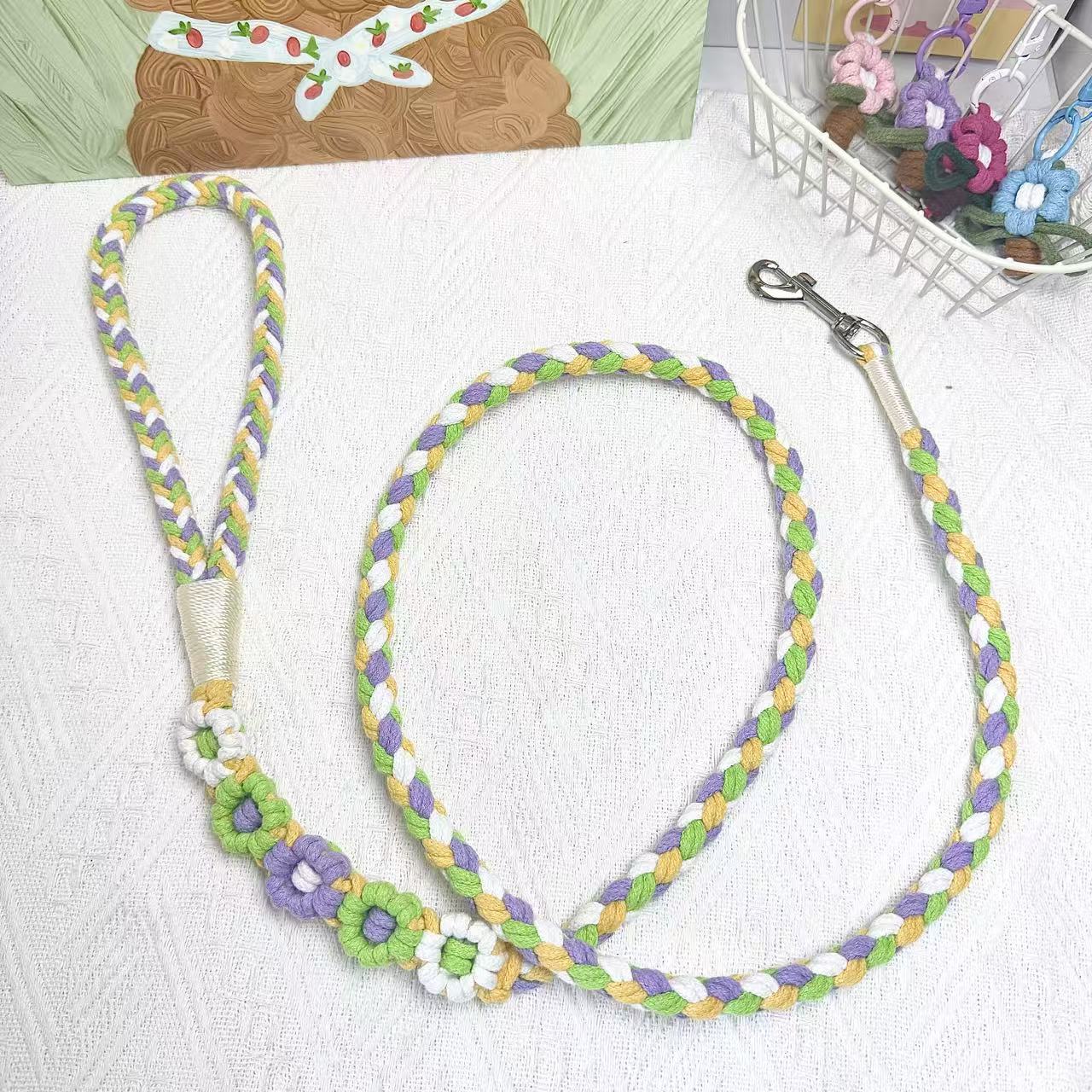 Handmade five flowers series yellow, purple, and green dog leash placed on a cotton cloth.