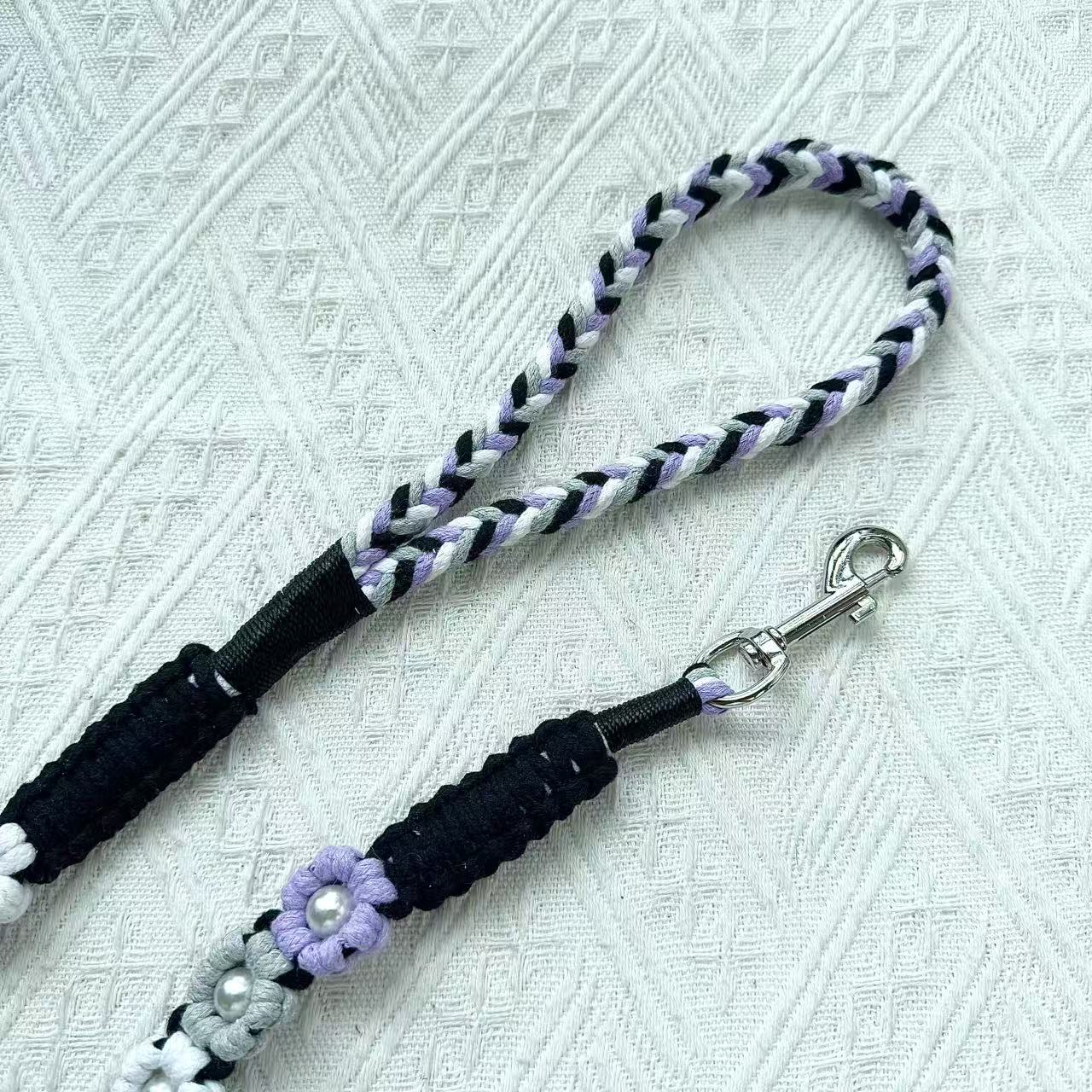 The soft handle and the clip of the handmade purple gray dog leash, featuring multiple beautiful woven flowers.