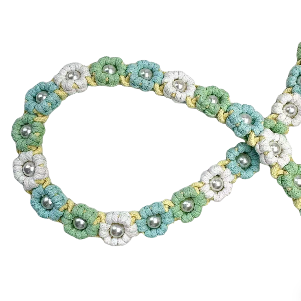 Dog leash decorated with numerous handcrafted flowers in fresh mint green and yellow tones.