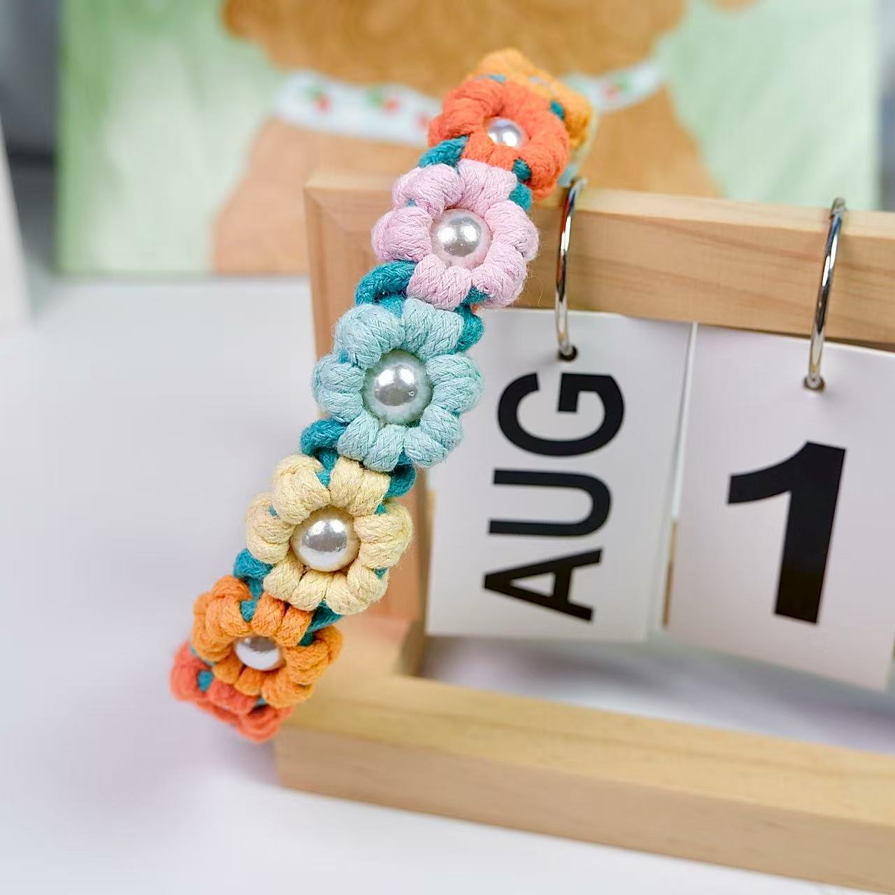 Handmade dog collar decorated with multiple handcrafted flowers in elegant pink, yellow, blue, red and orange tones.