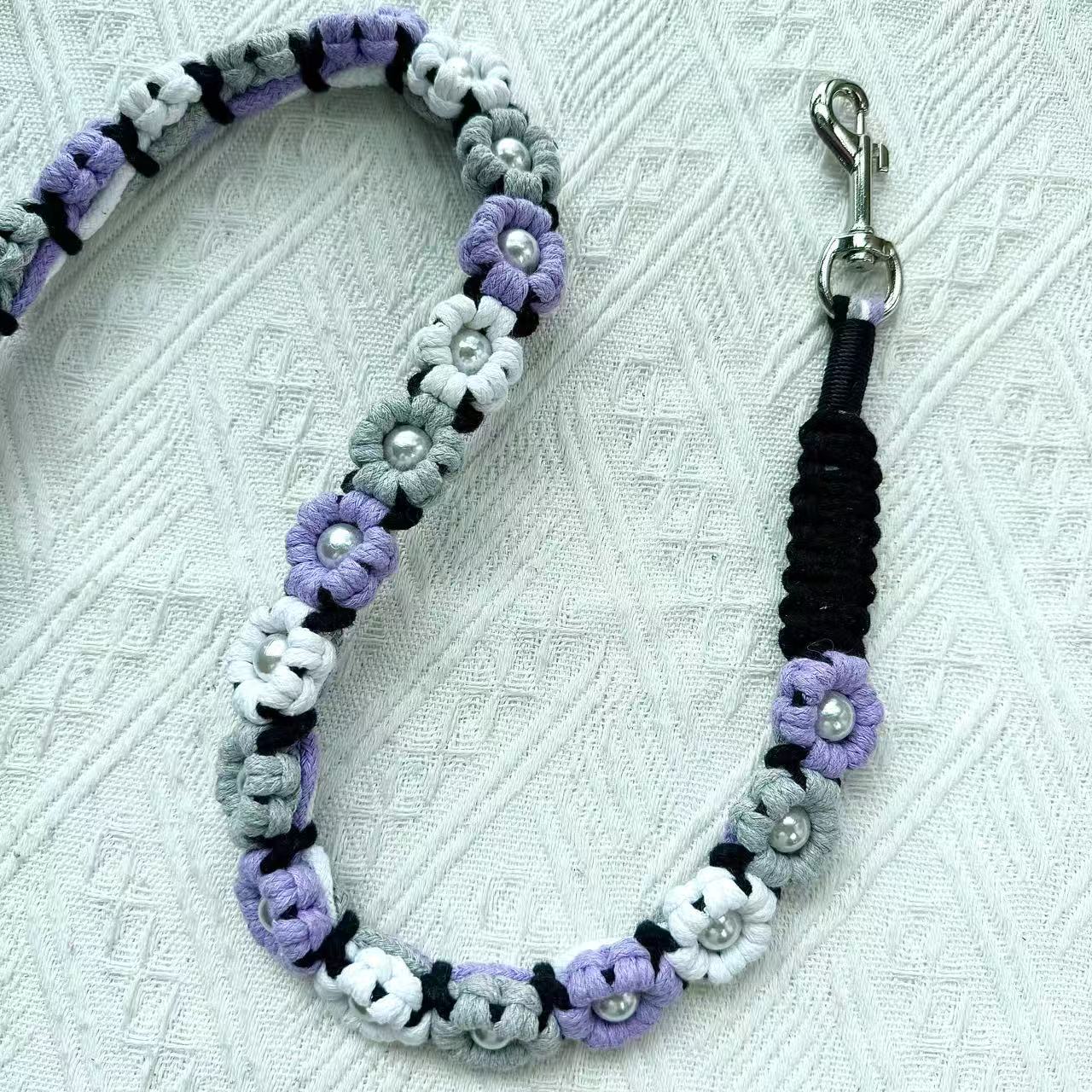 Dog leash decorated with numerous handcrafted flowers in elegant purple and gray tones.
