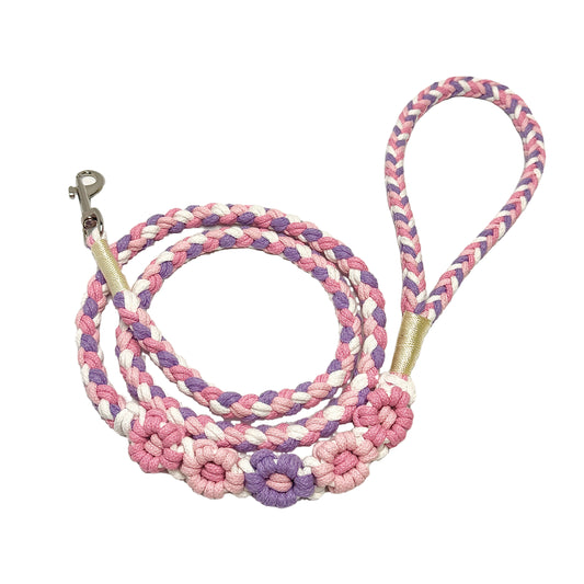 Purple and pink five-flower handmade dog leash coiled together, displaying its overall design with a cute and elegant look.