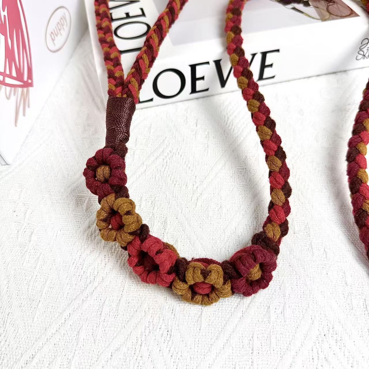The handmade red and brown dog rope leash, detail of the five flowers.