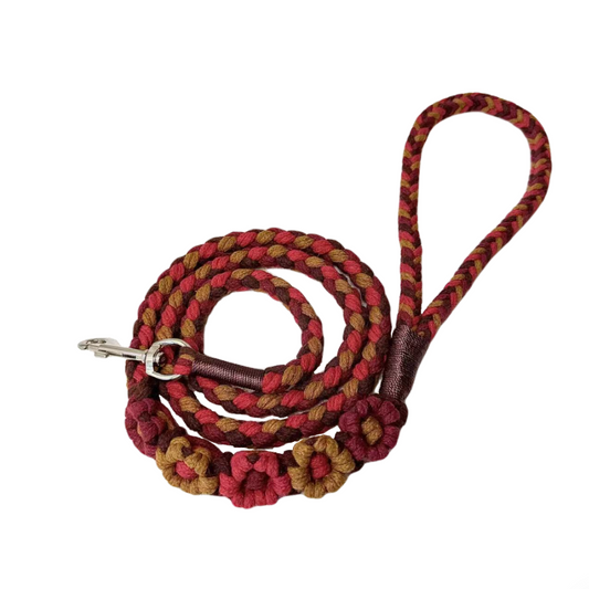 Red and brown five-flower handmade dog leash coiled together, displaying its overall design with a calm and charming look.