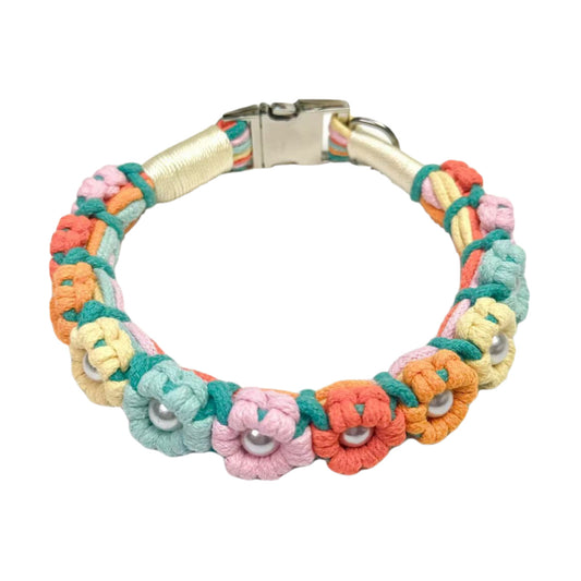 A vibrant pink, yellow, red, blue, and orange handmade dog collar featuring braided flower patterns with pearl embellishments, adding a touch of delight to your pet's life.